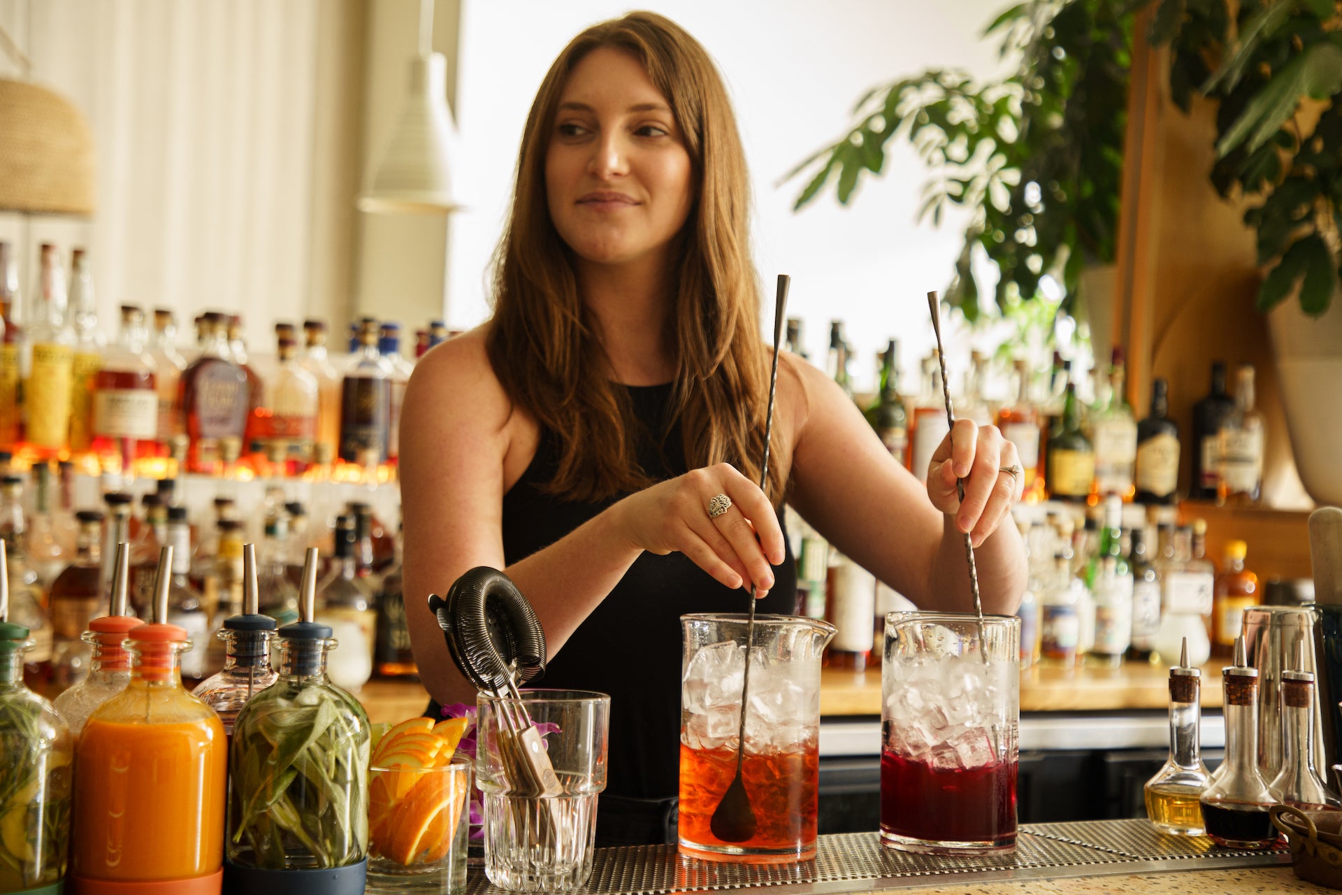 Professional bartender mixing drinks behind a bar
