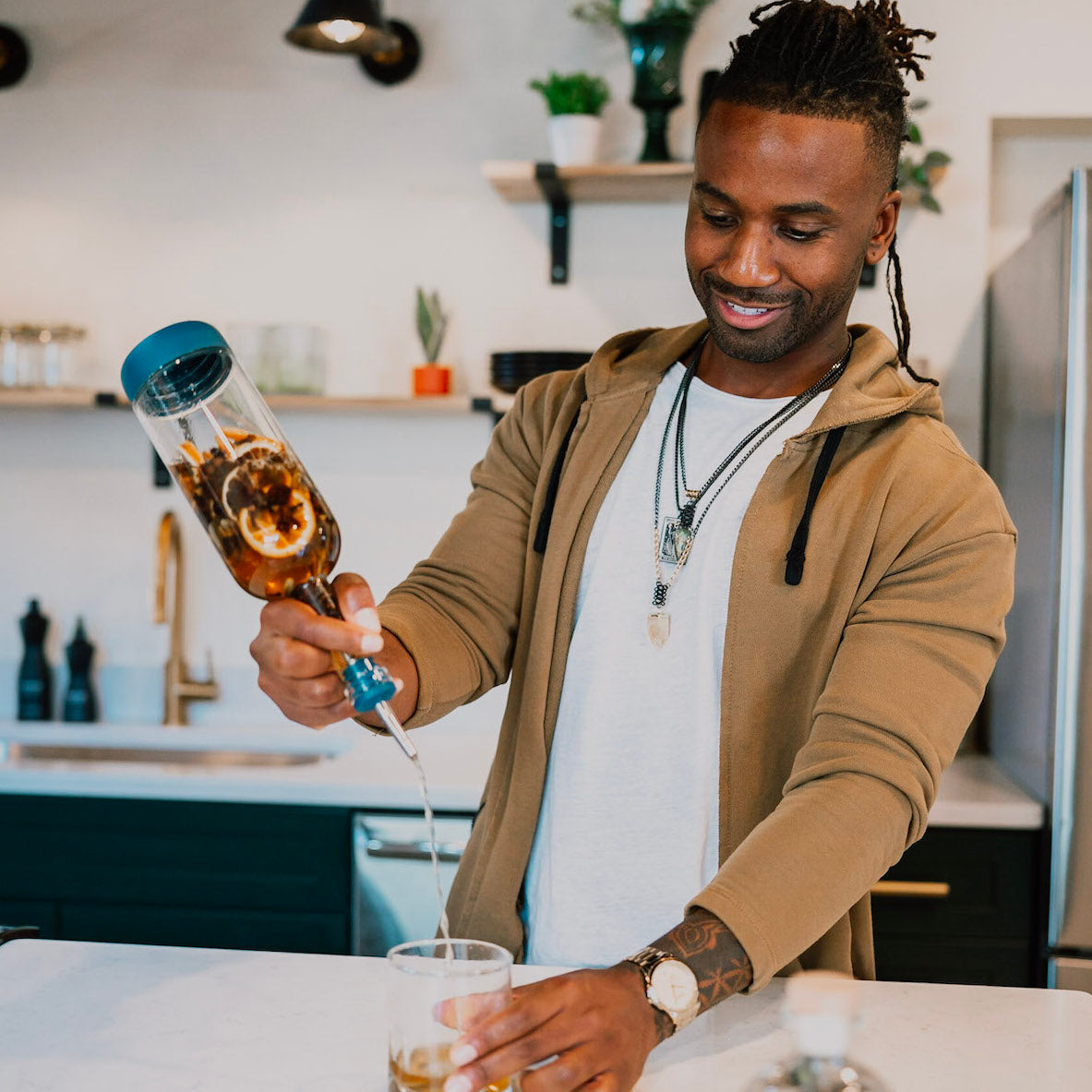 Man pouring infused spirit for his cocktail recipe