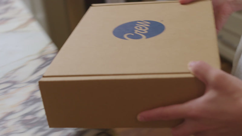 A young woman unboxing a cocktail kit